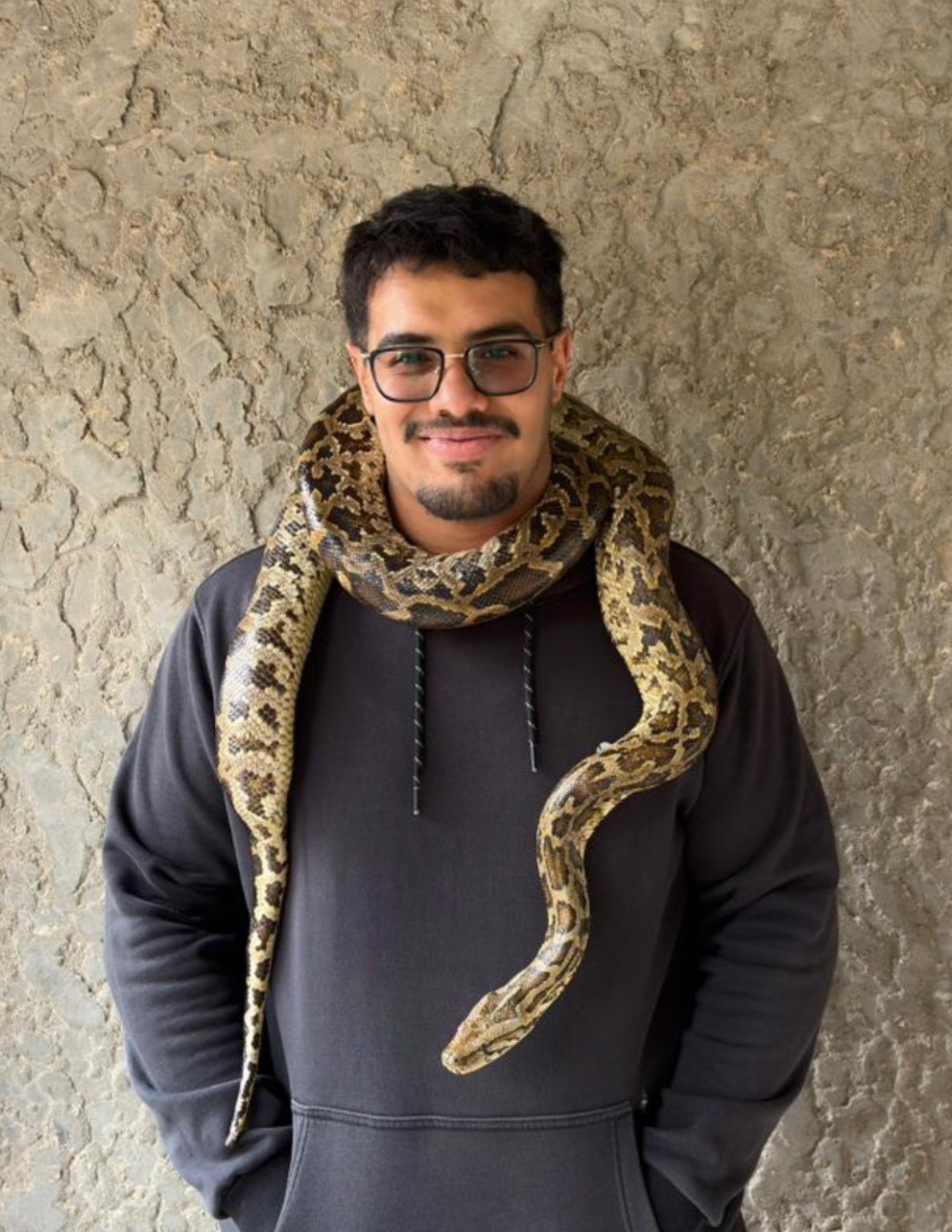 Adam Mahfouz with a snake around his shoulders